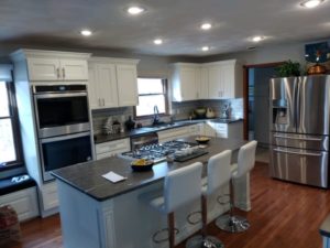 Diamond Distinction Coconut Cabinets with Meteor Shower Granite Countertops